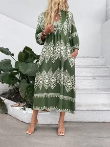 Detail of green bohemian maxi dress with ethnic prints and side pockets