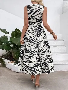 Detail of elegant zebra print dress showing elastic waist and layered ruffle skirt