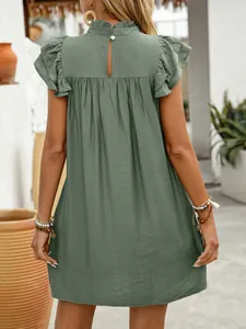 Detail view of the lotus leaf sleeves and pleated texture on the dark green summer dress
