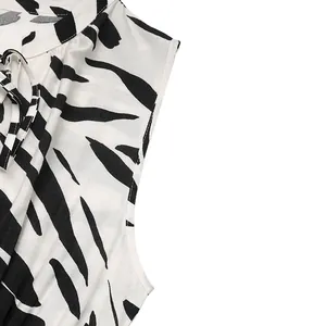 Close-up of elegant V-neck zebra print dress with tie-up detail and textured fabric