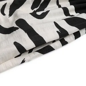 Close-up of zebra stripe print fabric with black artistic strokes on beige background