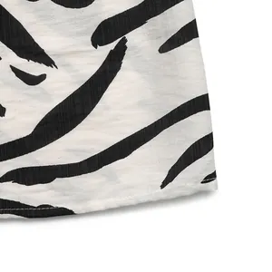 Close-up of zebra print sleeveless V-neck dress showing fabric texture and neat stitching