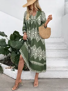 Close-up of bohemian deep green dress with white vintage geometric prints on soft fabric