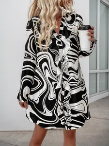 Close-up of Ruffle detail and V-neckline on fluid black and white floral print dress