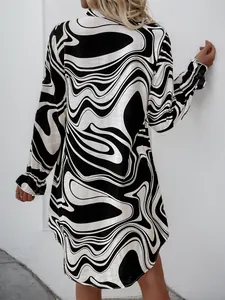 Detail view of the back of a ruffle-sleeve shirt dress with black and white wavy prints