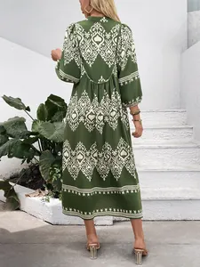 Back view of bohemian olive green midi dress with vintage geometric patterns and ruffles