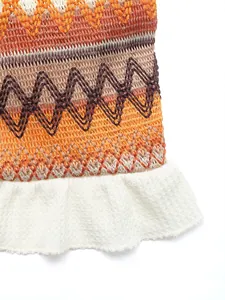 Close-up of chevron knit texture and white ruffle hem on vacation style skirt