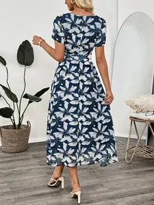 Elegant navy floral midi dress with puff sleeves and cinched waist for a French summer style
