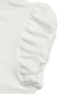 Close-up of elegant puff sleeves with ruffle details on a white cotton summer t-shirt