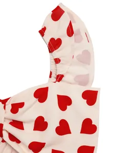 Detail of red heart print fabric with ruffle elastic strap and large bow decoration