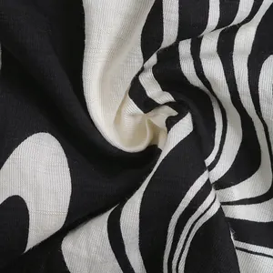 Close-up of black and white textured fabric showing woven pattern and ruffles