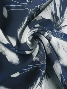Detailed view of lightweight blue and white floral chiffon fabric with soft elegant drape