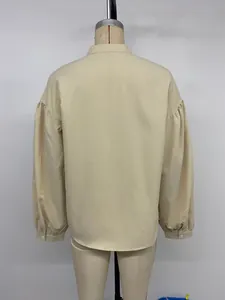 Back view of apricot long-sleeve blouse featuring puff sleeves and buttoned cuffs on a mannequin