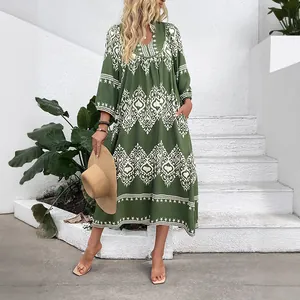 Bohemian loose maxi dress with white geometric floral print in deep forest green color