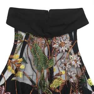 Detail of high collar black lace jumpsuit with floral daisy embroidery and mesh