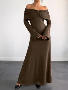 Detail showing the ribbed knit texture and elegant brown Bardot neckline dress fabric