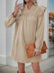 Detail of ruffled stand collar and V-neckline on a loose khaki long sleeve dress