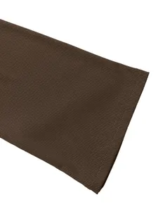 Close-up of dark brown ribbed fabric with durable double-stitch seams for autumn dress