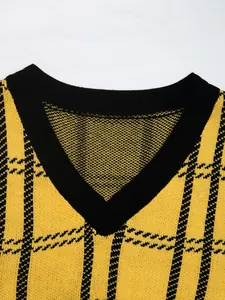 Detail of V-neck collar with black ribbed trim on yellow plaid knitted vest