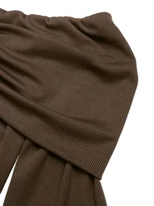 Detailed macro view of the premium dark brown ribbed knit fabric with vertical texture