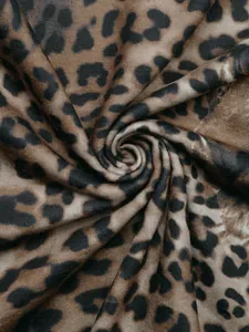 Dettaglio macro del tessuto in maglia leopardata con trama morbida e drappeggio a spirale