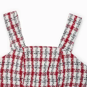 Close-up of red and white plaid tweed fabric texture and neckline stitching detail