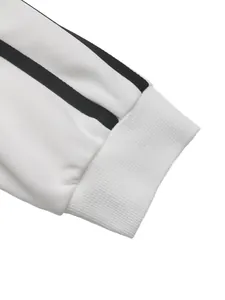 Close-up of white ribbed cuff with two black parallel stripes on a long-sleeve sweatshirt