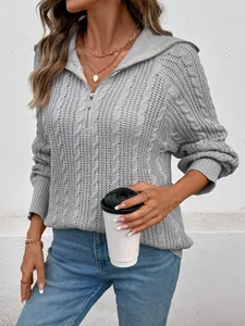 Dettaglio della maglia a trecce grigio chiaro e della cerniera sul maglione accogliente