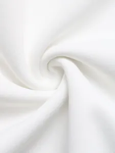 Macro shot of high-quality white knitted fabric with soft texture and refined ribbing