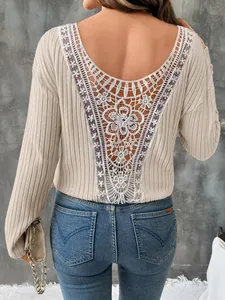 Détail du dos en V profond avec dentelle florale blanche sur un haut en maille beige