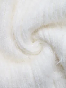 Macro detail of soft white knit fabric featuring premium fluffy long-fiber texture
