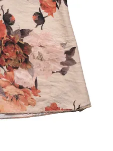 Close-up of vintage floral print fabric with elegant rose patterns and neat hem stitching