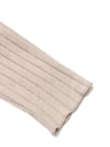 Close-up of ribbed knit texture and cuff detail on beige long sleeve off-shoulder top