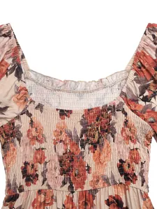 Detail of square neckline with ruffles and elastic smocked floral fabric for women dress
