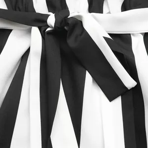 Detail of high-waist striped shirt with elegant tie-up belt and elastic waistband