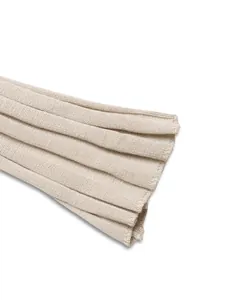 Gros plan des poignets en maille côtelée sur une robe beige montrant la texture