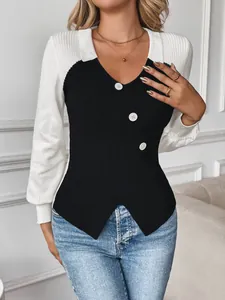 Women's V-neck contrast knit sweater with white lapels and button detail on black rib fabric