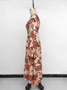 Detail of smocked waist and vintage floral print on elegant long-sleeved dress