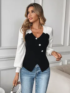 Detail of V-neck color-block knit sweater with white decorative buttons and ribbed texture