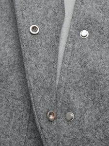 Detail of silver snap buttons on grey wool blend jacket with textured fabric