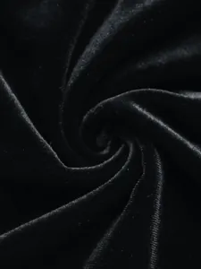 Macro shot of premium black velvet fabric showing soft texture and silky satin luster