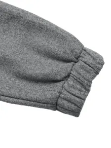 Detail of grey jacket elastic cuff featuring thick fleece texture and neat stitching