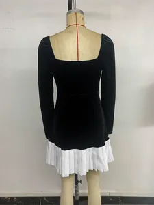 Back view of a black velvet dress featuring white pleated hem and elegant vintage silhouette