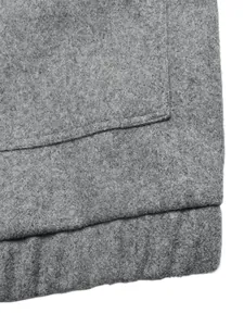 Close-up of premium gray fabric texture and high-quality stitching on a women's jacket