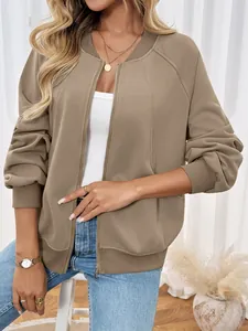 Detailed close-up of khaki zip-up bomber jacket featuring ribbed collar and metal zipper