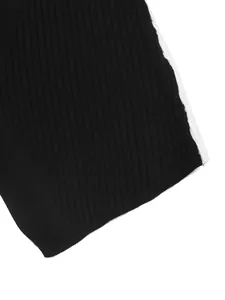 Close-up of contrast color stitching on premium black ribbed knit sweater fabric