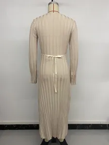 Détail du dos d'une robe longue en maille beige avec un élégant nœud à ruban à la taille