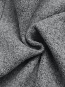 Detailed close-up of premium gray wool blend fabric with grainy texture and soft felt finish