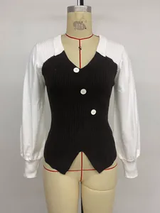 Detailed view of the vertical ribbed texture and white buttons on the knit sweater