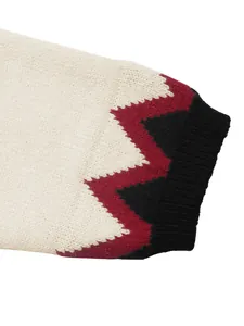Detail of tricolor wavy knit pattern and ribbed cuffs on a cozy fall sweater